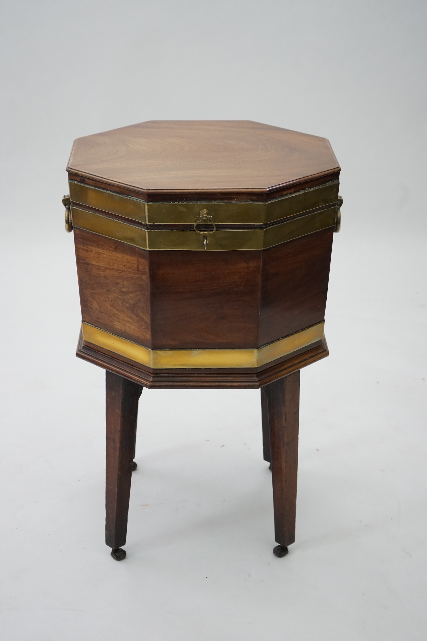 A George III mahogany triple brass banded octagonal cellarette